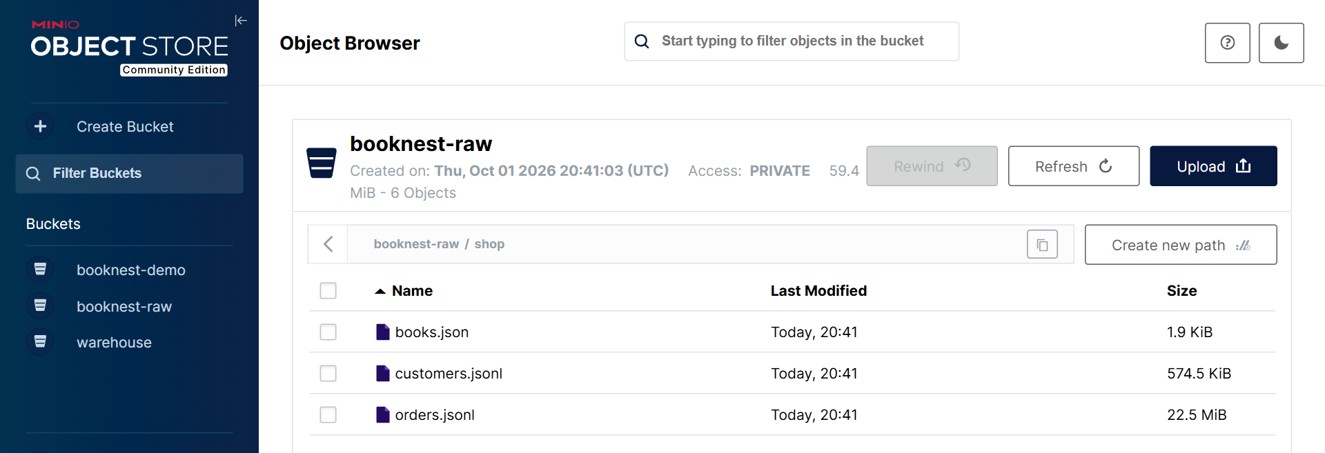 The community console's object browser on l1-minio, showing booknest-raw/shop after Section 8.2.7's load